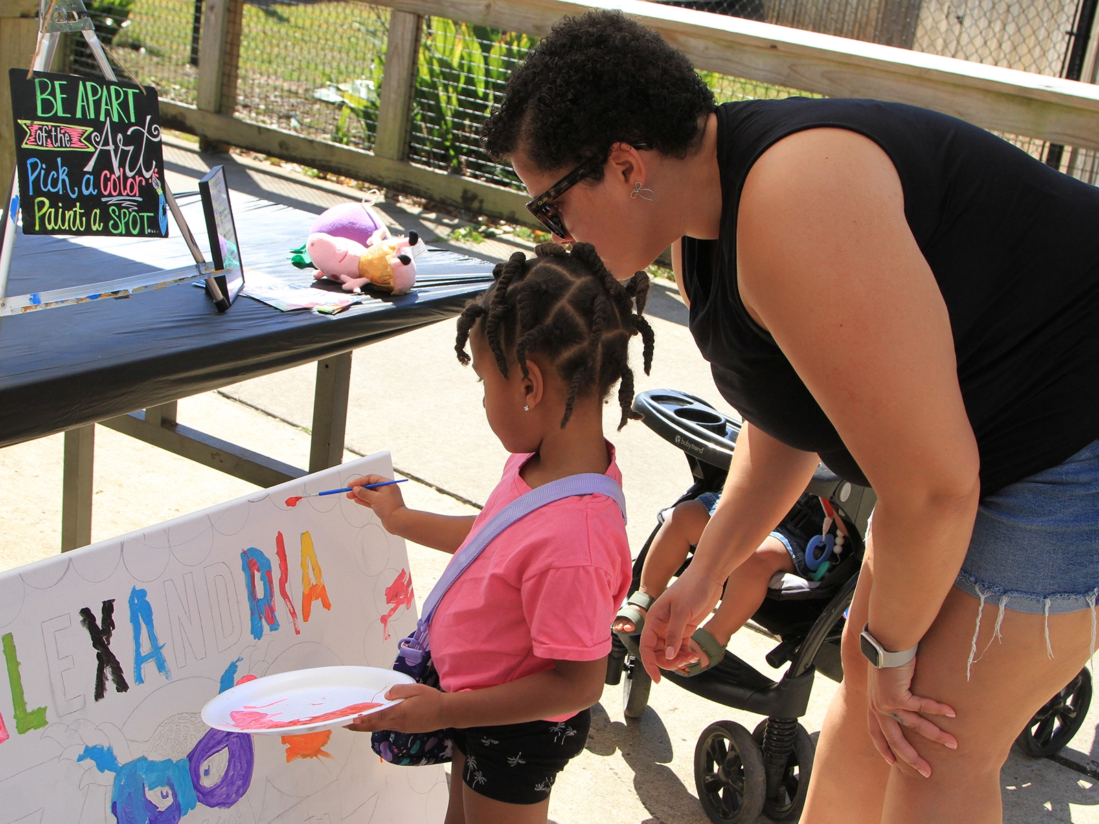 child and parent participating in craft