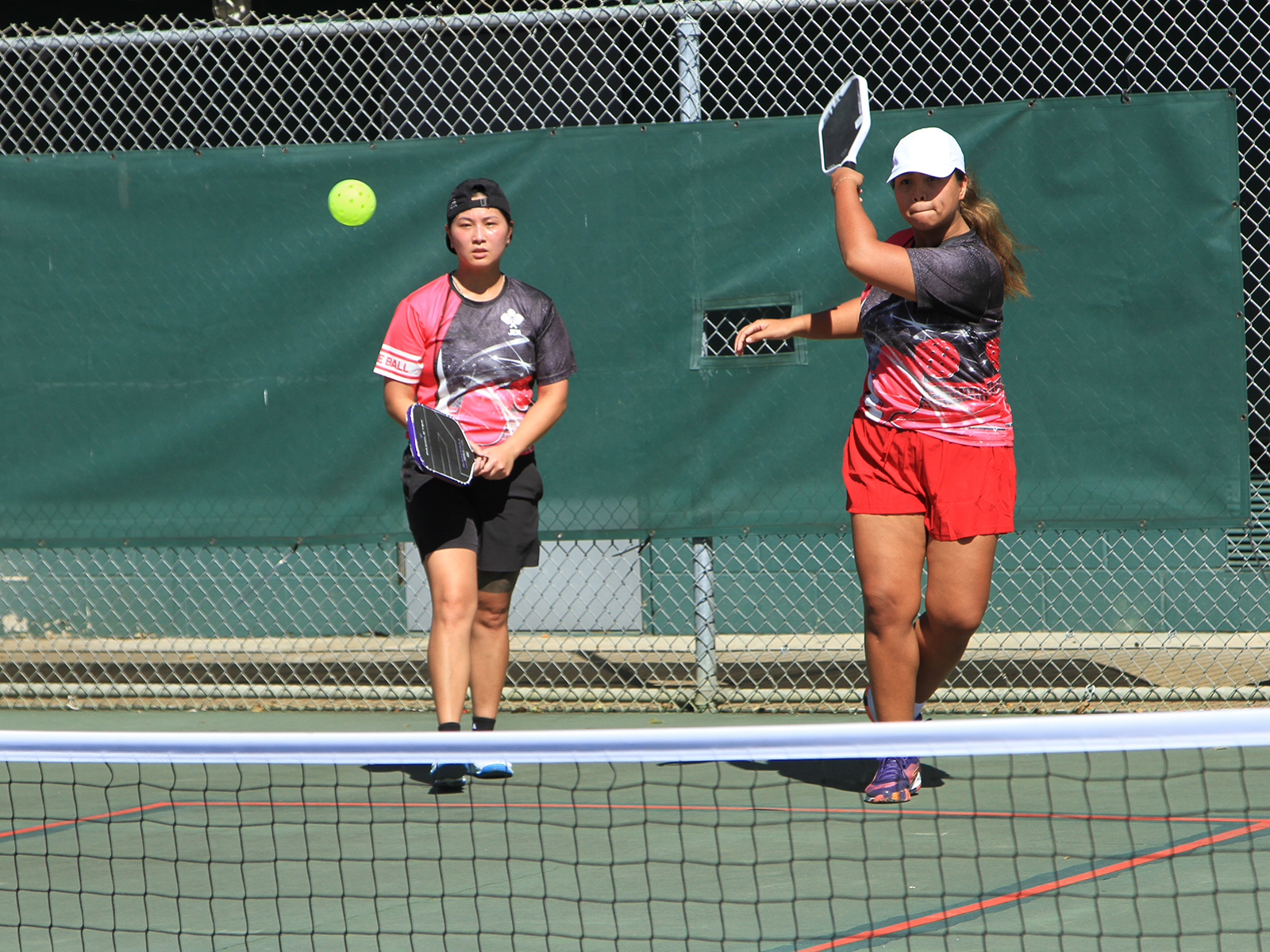 women playing pickleball