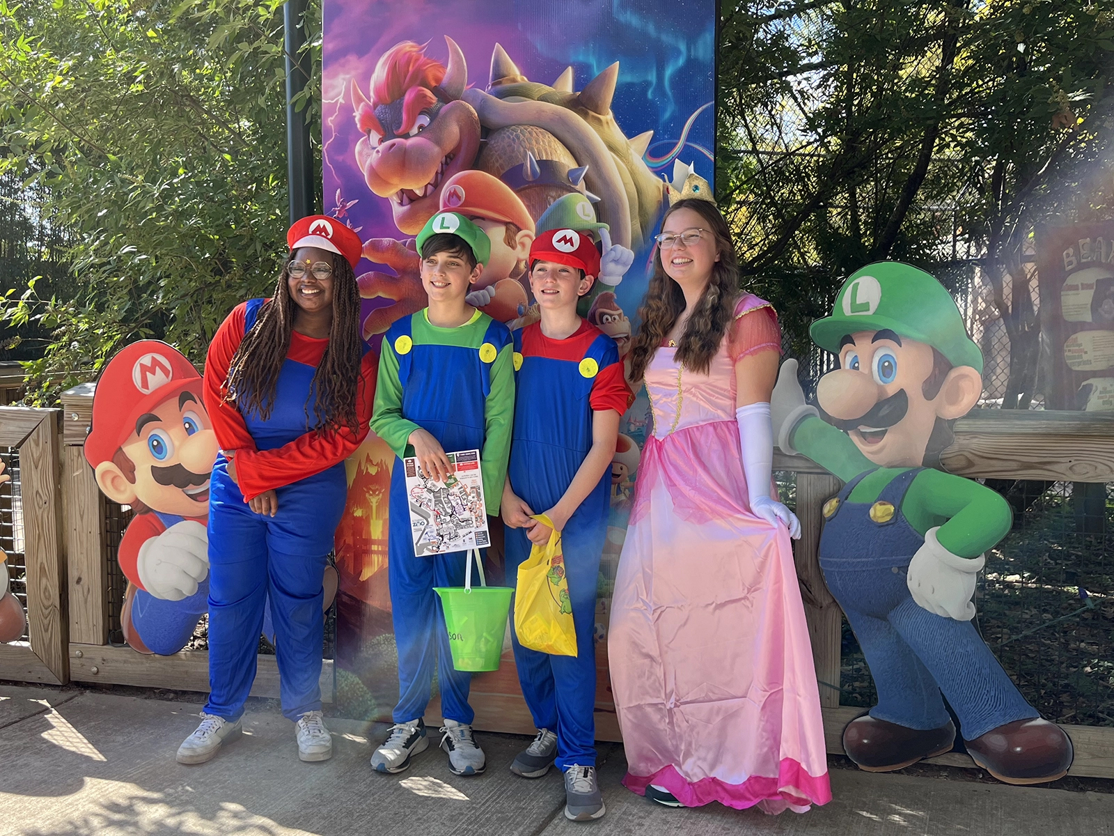 students in costume posing with child