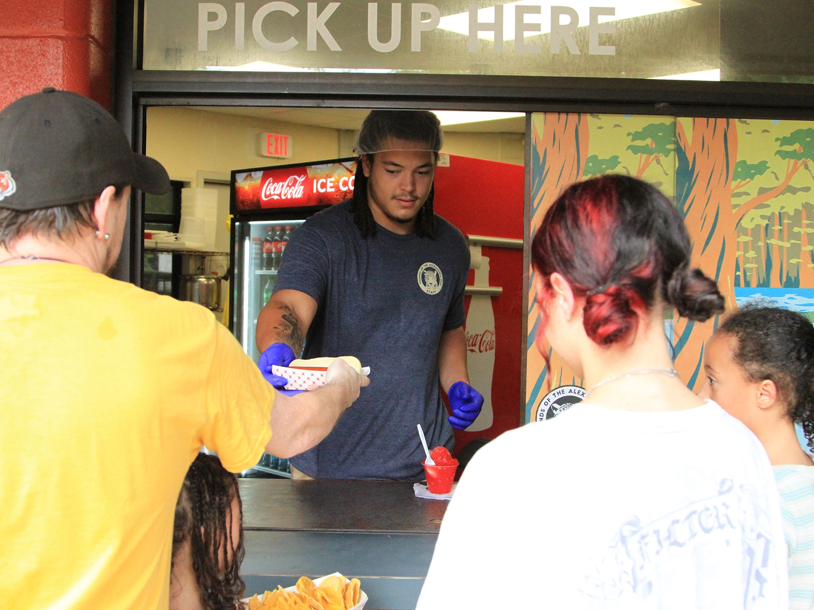guest service employee serving food at Cafe