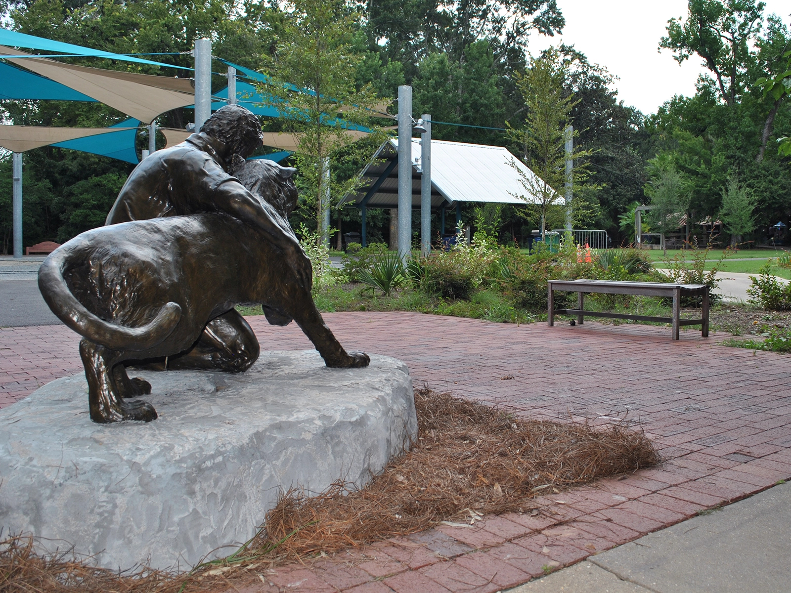 statue and brick area with festival plaza in the background