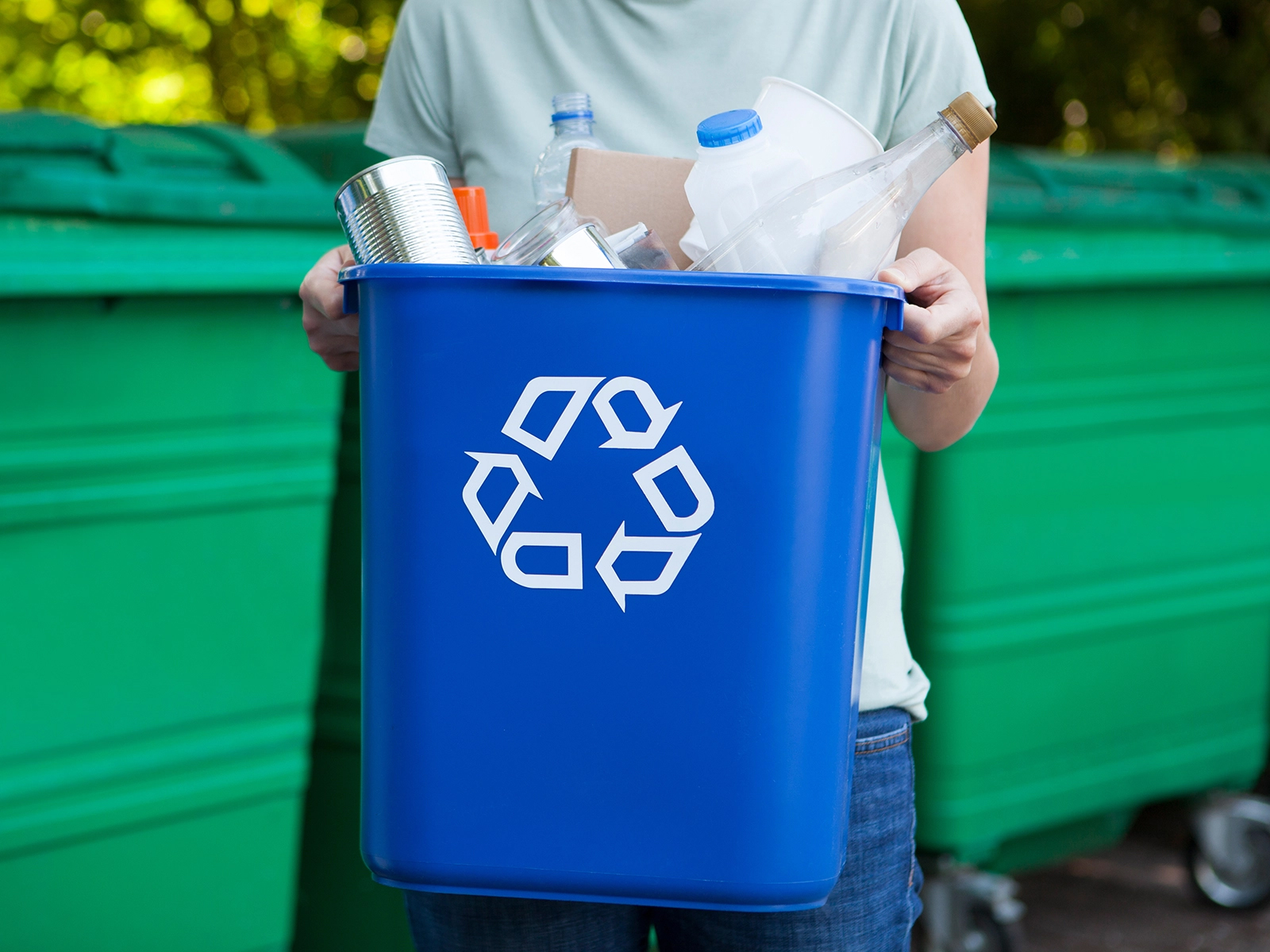 man holding recycle container