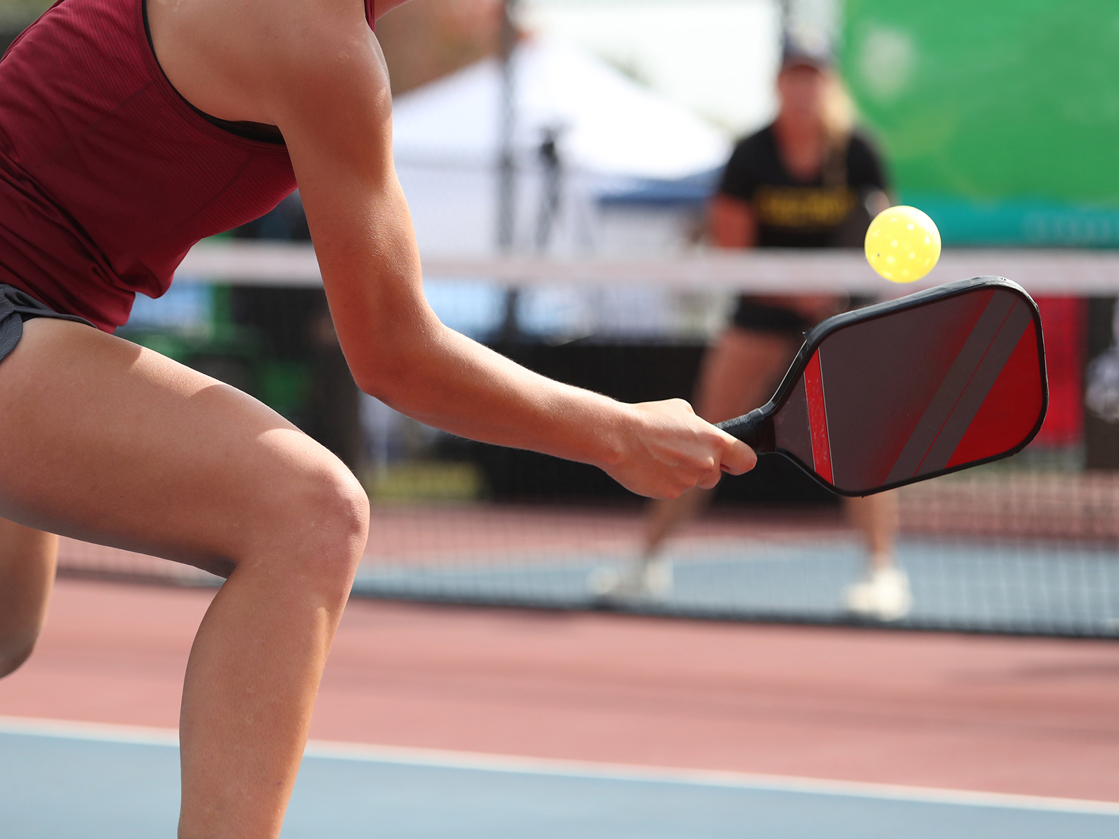 pickleball player hitting ball